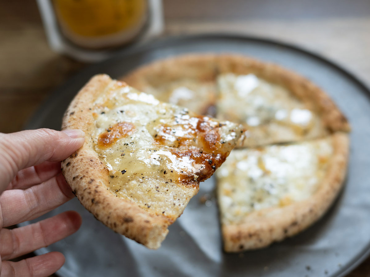 チーズピザに発酵レモンのハニーソースをかけた様子